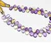 Natural Bi Color Ametrine Smooth Pear Drop Briolette Beads Strand Sold per 6 beads and Size 11mm to 12mm approx. Ametrine, also known as trystine or by its trade name as bolivianite, is a naturally occurring variety of quartz. It is a mixture of amethyst and citrine with zones of purple and yellow or orange 